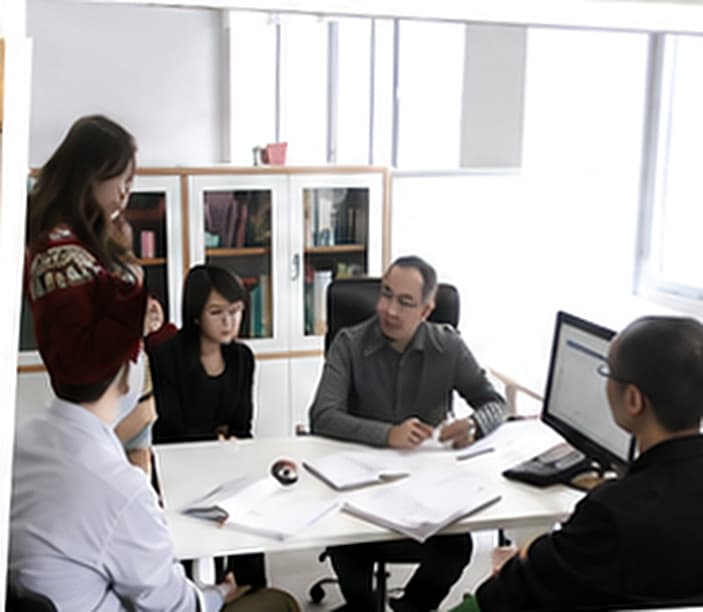 DEWANG ART colleagues reviewing a project during an office meeting