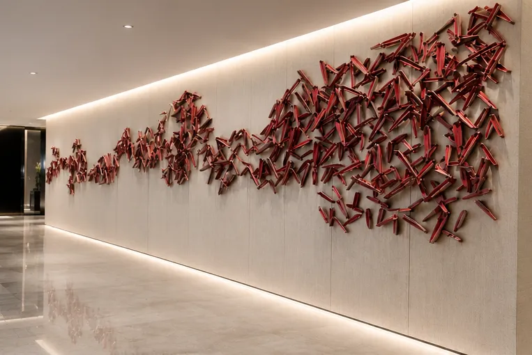Wide view of the red sculptural wall art installation